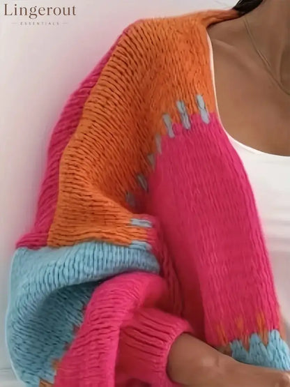 Candy Cloud Cardigan – oversized color block knit in orange, pink, blue, and contrasting tones.